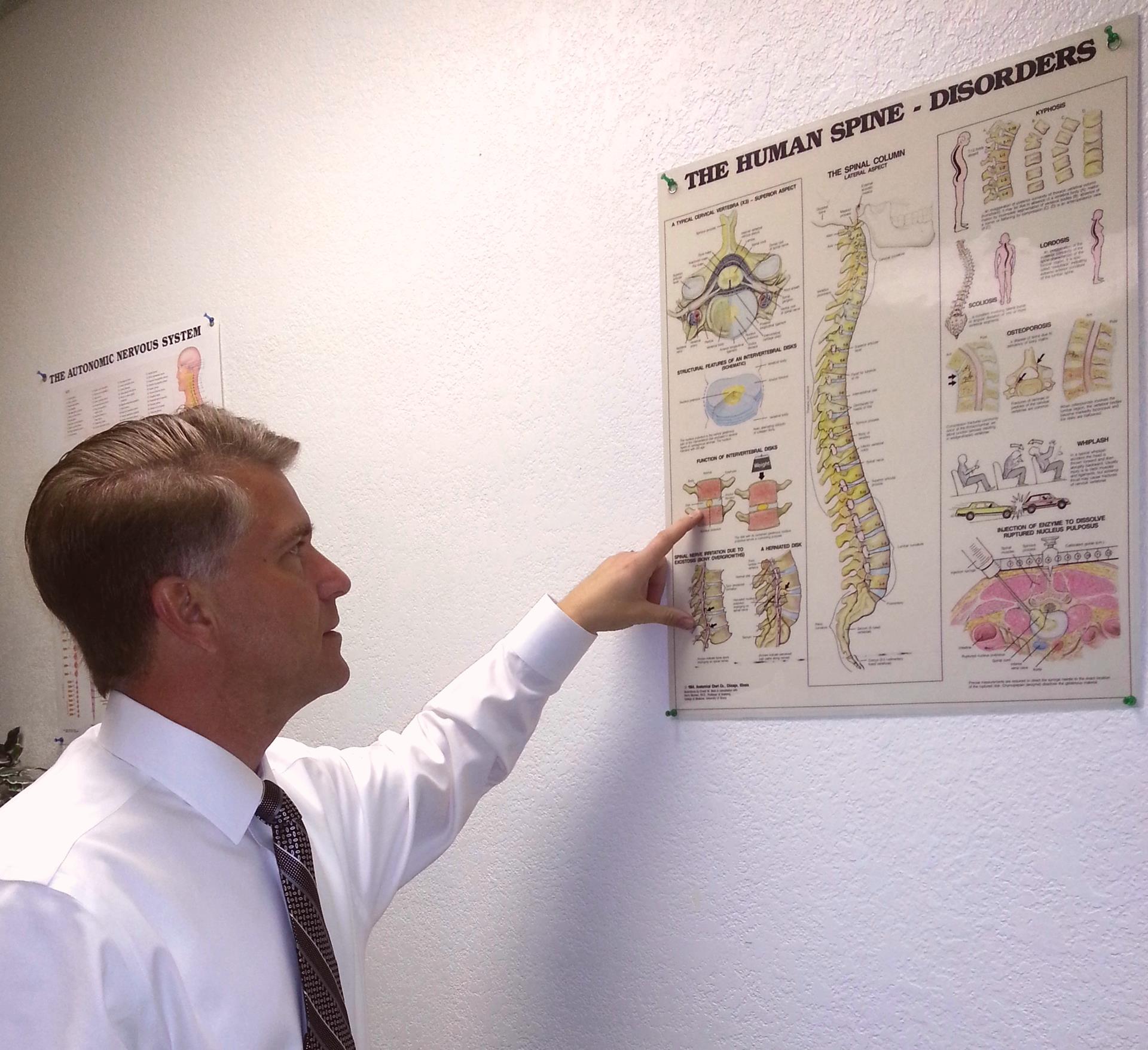 Dr. Tomburo explaining spinal disorders chart